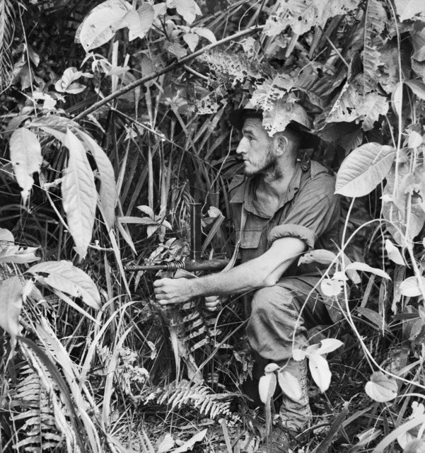 An Australian soldier with an Owen gun in dense jungle at Sanananda, Papua, in 1943